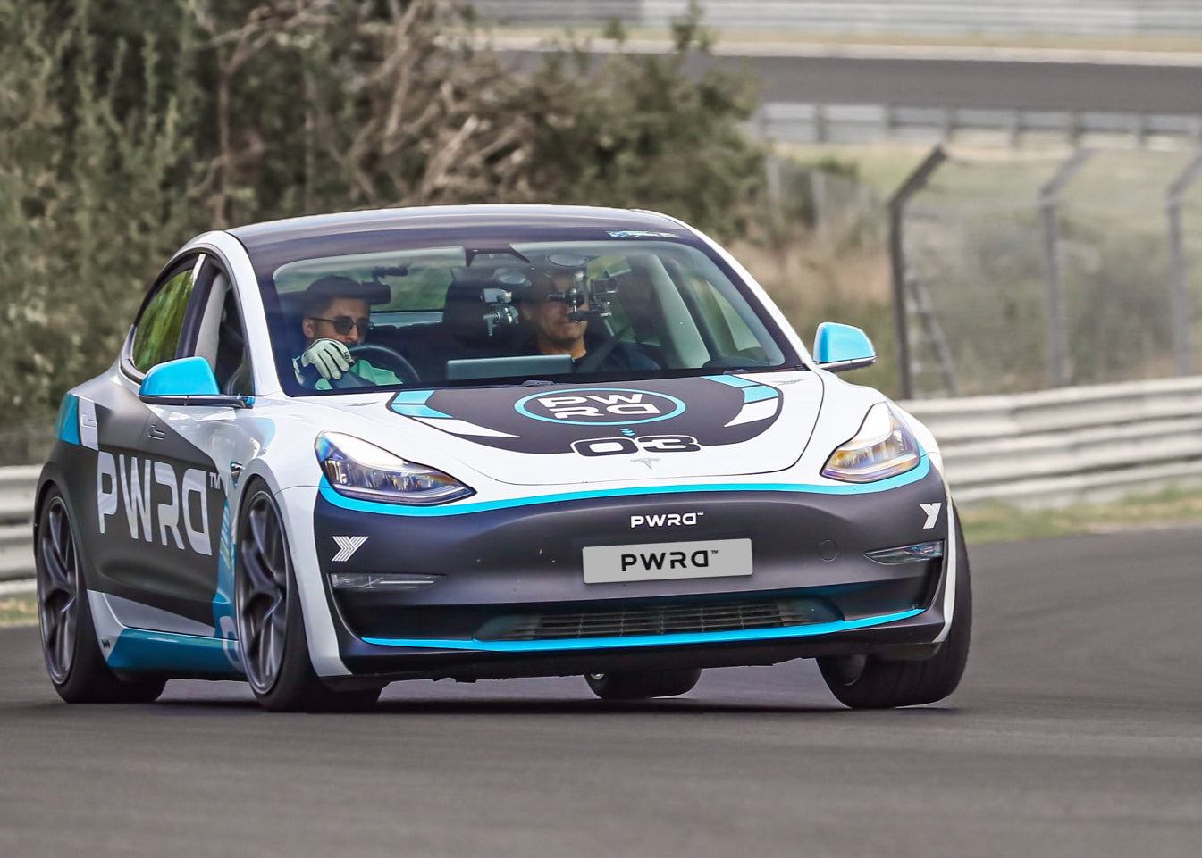 Electric car on a track with 'PWRD' branding