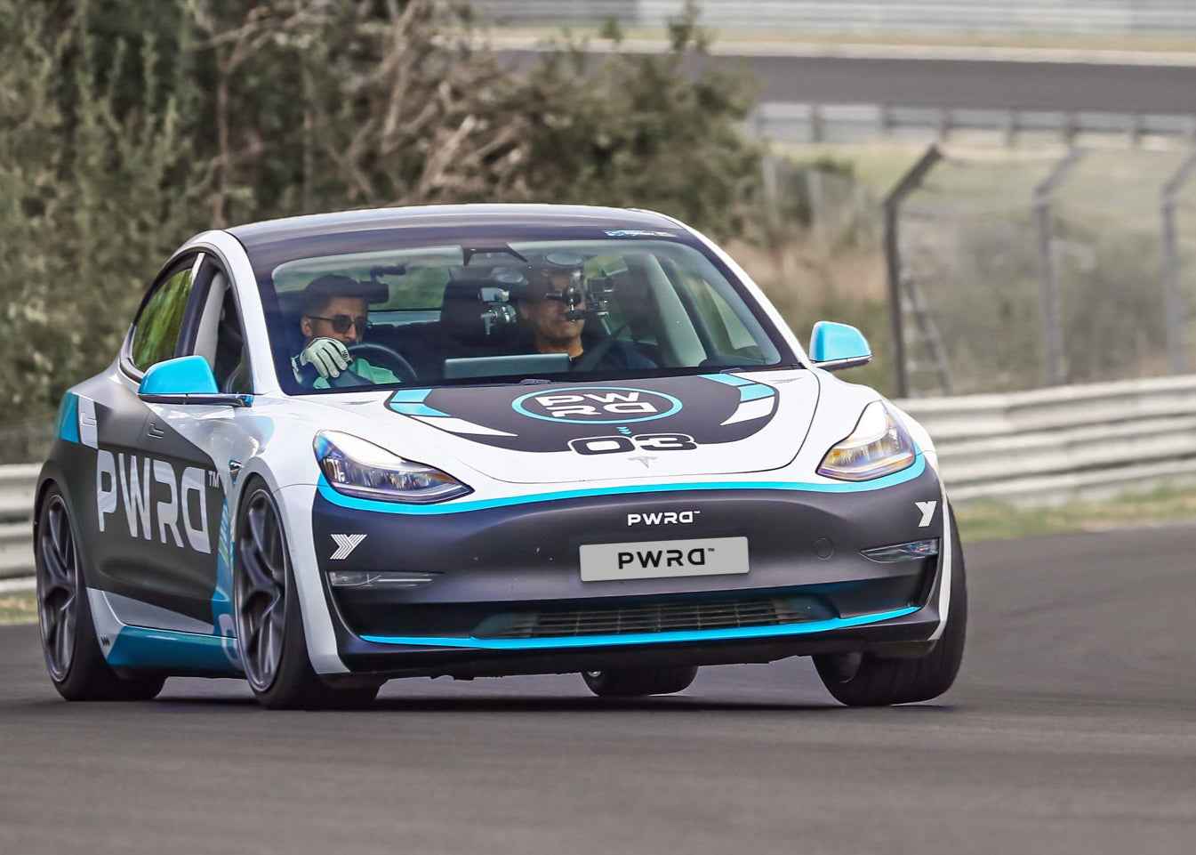 Electric car on a track with 'PWRD' branding
